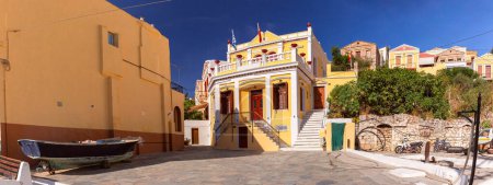 Panoramic view of town square lined with traditional colorful buildings on Symi Island, Greece