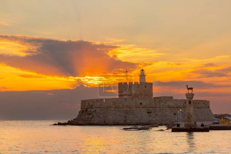 Panoramic view of the Fort of St Nicholas and deer statue at sunset in Rhodes, Greece