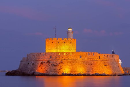 The Fort of St Nicholas illuminated at night in Rhodes, Greece