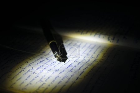 an old fountain pen resting on a manuscript-stock-photo