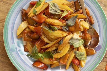 Photo for Fried peppers and potatoes for a sicilian peperonata - Royalty Free Image