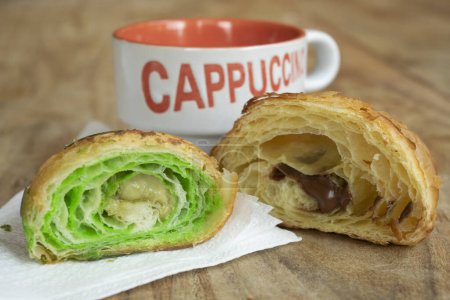 Photo for Cappuccino with pistachio and chocolate croissant - Royalty Free Image
