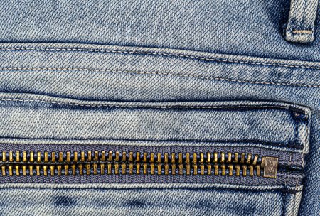 Téléchargez les photos : Metal zipper on light blue jeans pocket. - en image libre de droit