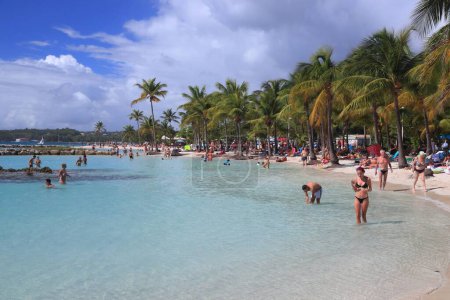 Photo for GUADELOUPE, FRANCE - DECEMBER 8, 2019: People spend beach vacation in Sainte Anne on Guadeloupe island. Guadeloupe has 650,000 annual visitors. - Royalty Free Image