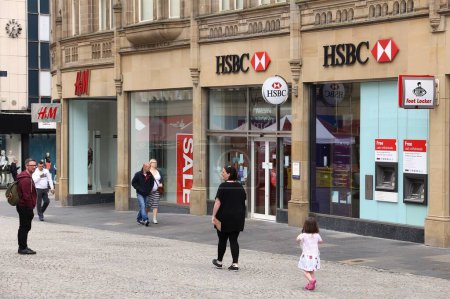 Photo for SHEFFIELD, UK - JULY 10, 2016: People walk by HSBC Bank branch in Sheffield, Yorkshire, UK. HSBC is one of largest bank groups in Europe. - Royalty Free Image