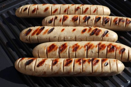 German food. Thuringian white sausage on a barbecue. Thuringia region of Germany (German: Thuringer Rostbratwurst). Protected geographical indication (PGI) local food in Europe.