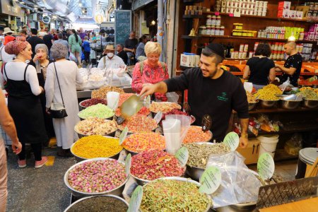 Photo for JERUSALEM, ISRAEL - OCTOBER 28, 2022: People visit herbal tea shop at Mahane Yehuda Market (or shuk) on morning before shabbat in downtown Jerusalem city. - Royalty Free Image