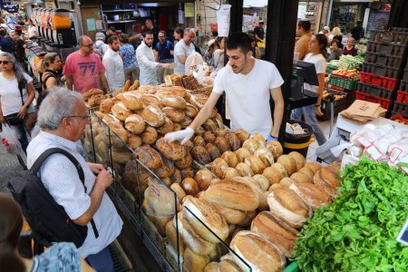 Photo for JERUSALEM, ISRAEL - OCTOBER 28, 2022: People visit bakery at Mahane Yehuda Market (or shuk) on morning before shabbat in downtown Jerusalem city. - Royalty Free Image