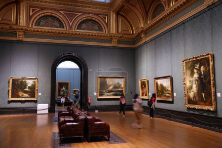 Photo for LONDON, UK - JULY 12, 2019: Tourists admire paintings in National Gallery in London. It is the 3rd most visited museum in the UK with 5.7 million annual visitors. - Royalty Free Image