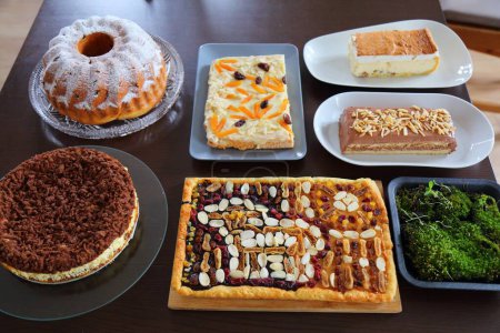 Easter cakes table in Poland. Easter pastry: babka cake, mazurek cakes and cheesecakes. Easter in Poland - Wielkanoc.
