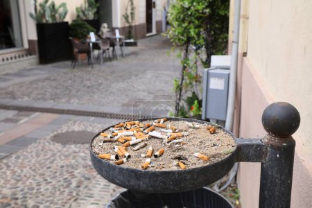 Photo for ALGHERO, ITALY - MAY 29, 2023: Public street ashtray cigarette butts in Alghero town, Sardinia island, Italy. - Royalty Free Image