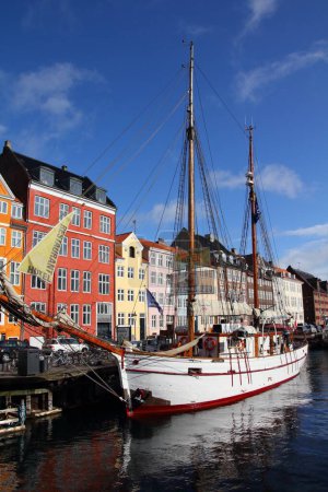 Photo for COPENHAGEN, DENMARK - MARCH 11, 2011: People visit Nyhavn district in Copenhagen, Denmark. Cophenhagen is the most visited city in Nordic countries with 1.3 million annual tourists. - Royalty Free Image