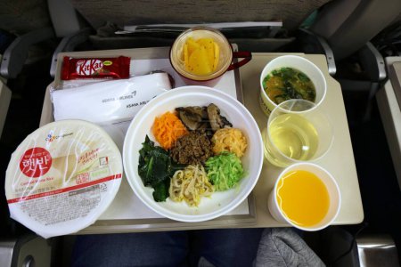 Photo for SEOUL, SOUTH KOREA - MARCH 25, 2023: Airline food table onboard Asiana Airlines. Korean cuisine dinner with bibimbap dish. - Royalty Free Image