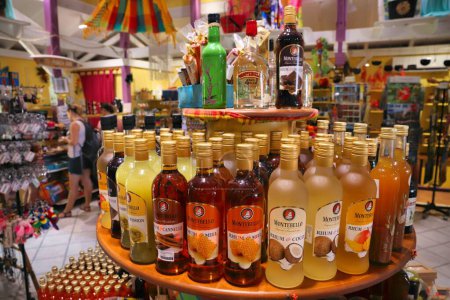 Photo for GUADELOUPE, FRANCE - DECEMBER 2, 2019: Tourist gift shop with coconut and honey flavored rum in Deshaies, Guadeloupe. Caribbean destination Guadeloupe has 650,000 annual visitors. - Royalty Free Image
