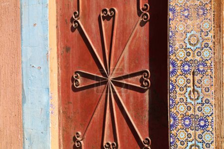 Taroudant city, Morocco. Decorated wall. Traditional riad door made of steel.