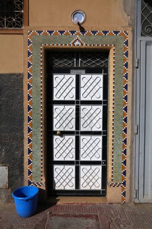Taroudant city, Morocco. Decorated wall. Traditional house door made of steel.