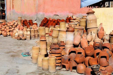 Taroudant street market artisanal products in Morocco. Moroccan handicraft ceramics in the souk. Tagine cooking pots.