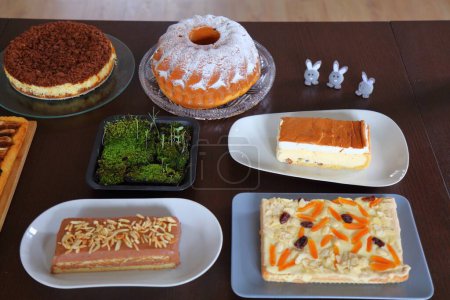 Easter cakes table in Poland. Easter pastry: babka cake, mazurek cakes and cheesecakes. Easter in Poland - Wielkanoc.