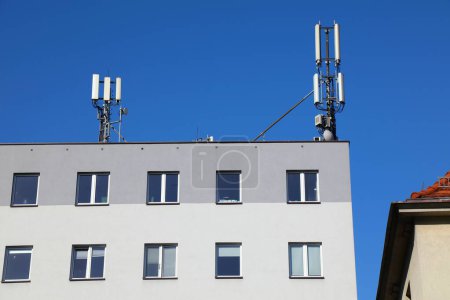 Mobile base station rooftop infrastructure in Europe. Mobile phone transmitters in Wodzislaw Slaski, Poland.
