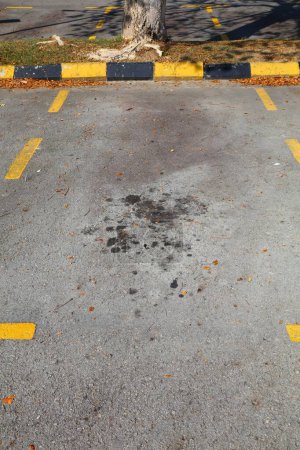 Parking oil stains in Malaysia. Ground pollution problem. Oil spots on asphalt surface.