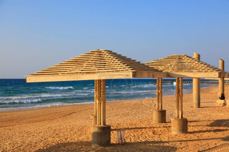 Sandy beach in Haifa, Israel. Dado Beach public infrastructure shades in Haifa.