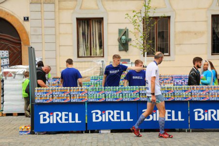 Photo for PRAGUE, CZECH REPUBLIC - MAY 5, 2024: Volunteers give out refreshments (Birell soft drinks) for runners in Prague Marathon, one of biggest marathon races in Europe. - Royalty Free Image