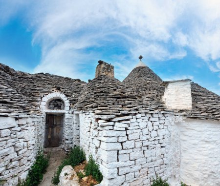 Photo for Trulli houses in main touristic district of Alberobello beautiful old historic town, Apulia region, Southern Italy - Royalty Free Image