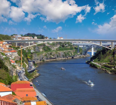 Photo for Ponte do Infante, Maria Pia Bridge and St John's Bridge over Douro river in Porto, Portugal. People are unrecognizable. - Royalty Free Image