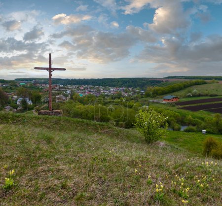 Photo for Wooden religious cross near Rukomysh Cave temple and spring country fields and village, Buchach District, Ternopil Region, Ukraine. - Royalty Free Image