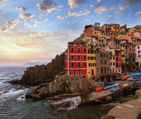Photo for Beautiful summer Manarola - one of five famous villages of Cinque Terre National Park in Liguria, Italy, suspended between Ligurian sea and land on sheer cliffs. People unrecognizable. - Royalty Free Image