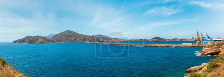 Téléchargez les photos : Port in Cartagena bay. Summer coast view with crane and shipping terminal (Costa Blanca, Spain). People unrecognizable. - en image libre de droit
