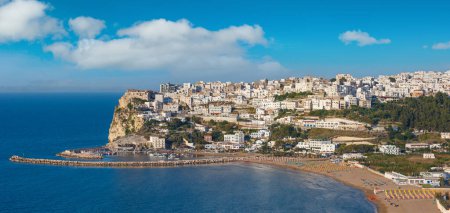 Foto de Summer sea perched Peschici beautiful town view, Gargano peninsula in Puglia, Italy. People unrecognizable. - Imagen libre de derechos