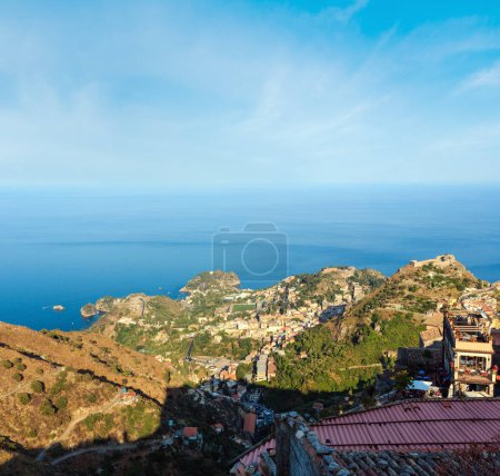 Photo for Beautiful Taormina sea coast panoramic view from  Castelmola mountain village and Castelmola roofs, Sicily, Italy. People unrecognizable. - Royalty Free Image