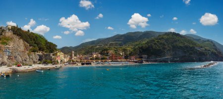 Photo for Beautiful summer Monterosso view from excursion ship. One of five famous villages of Cinque Terre National Park in Liguria, Italy. People unrecognizable. - Royalty Free Image