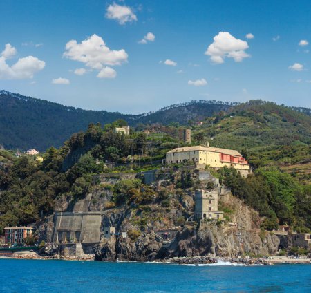 Photo for Monterosso view from excursion ship. One of five famous villages of Cinque Terre National Park in Liguria, Italy, suspended between Ligurian sea and land on sheer cliffs. People unrecognizable. - Royalty Free Image