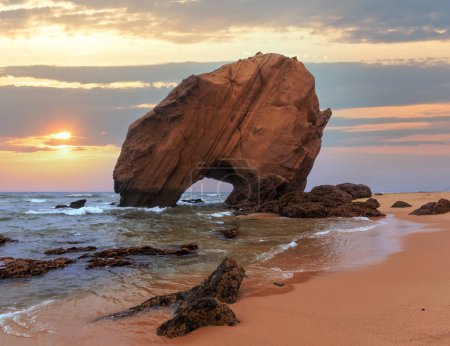 Photo for Sandy beach Praia de Santa Cruz with rock formation (Portugal). Misty weather. - Royalty Free Image