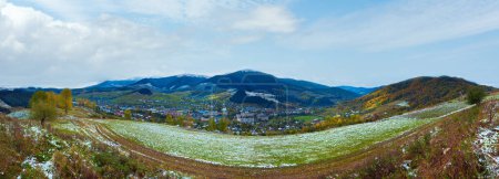 Photo for October Carpathian mountain with first winter snow on dirty road and village in valley. Ukraine. - Royalty Free Image