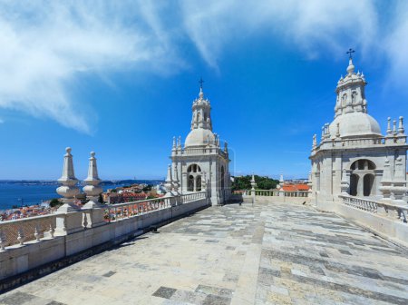 Roof with white bell towers on blue sky background.  Monastery of St. Vincent Outside the Walls, or Church (Iglesia) de Sao Vicente de Fora in Lisbon, Portugal.