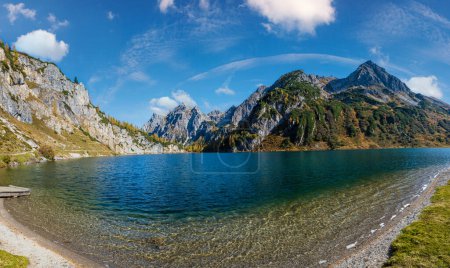 Photo for Sunny autumn alpine Tappenkarsee lake and rocky mountains above, Kleinarl, Land Salzburg, Austria. Picturesque hiking, seasonal, and nature beauty concept scene. - Royalty Free Image