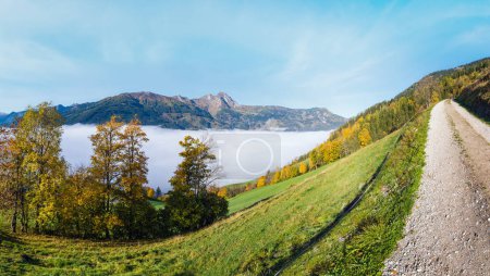 Photo for Sunny idyllic autumn alpine scene. Peaceful misty morning Alps mountain view from hiking path from Dorfgastein to Paarseen lakes, Land Salzburg, Austria. Picturesque hiking and seasonal concept scene. - Royalty Free Image