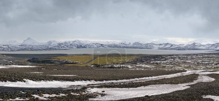 Photo for Iceland highlands autumn ultrawide view. Lava fields of volcanic sand in foreground. Hrauneyjalon lake and volkanic snow covered mountains in far. - Royalty Free Image