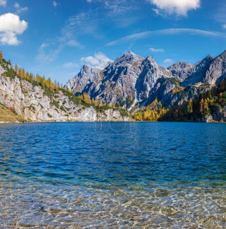 Photo for Sunny autumn alpine Tappenkarsee lake and rocky mountains above, Kleinarl, Land Salzburg, Austria. Picturesque hiking, seasonal, and nature beauty concept high resolution scene. - Royalty Free Image