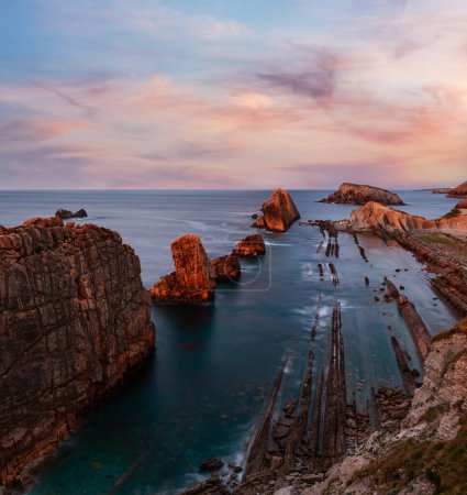 Photo for Atlantic ocean rocky coastline near Portio Beach (Pielagos, Cantabria, Spain) evening view. - Royalty Free Image