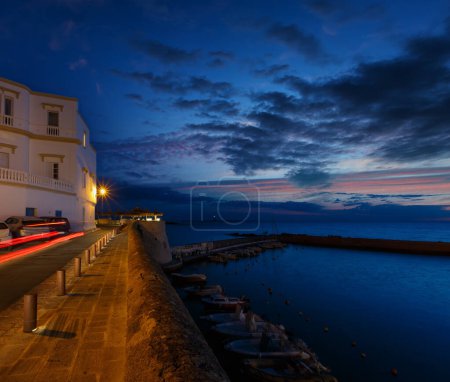 Photo for Evening dusk in Gallipoli, province of Lecce, Puglia, southern Italy.  View from walls of Angevine-Aragonese medieval Castle fortress - Royalty Free Image