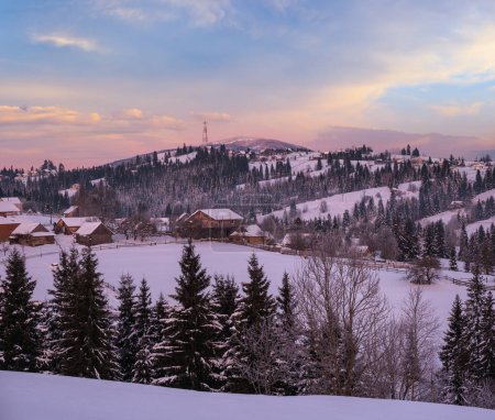 Photo for Small and quiet alpine village and winter sunrise snowy mountains around, Voronenko, Carpathian, Ukraine. - Royalty Free Image