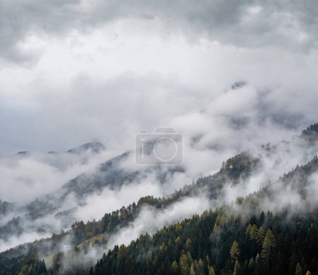 Photo for Mystic cloudy and foggy autumn alpine mountain slopes scene. Austrian Lienzer Dolomiten Alps. Peaceful picturesque traveling, seasonal, nature and countryside beauty concept scene. - Royalty Free Image