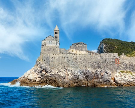 Photo for Beautiful medieval fisherman town of Portovenere (UNESCO Heritage Site) view from sea (near Cinque Terre, Liguria, Italy). Church Chiesa di San Pietro. - Royalty Free Image