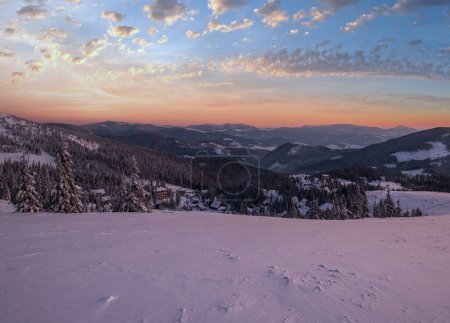 Photo for Picturesque winter  morning pre sunrise alps. View of famous Ukrainian Dragobrat ski resort from Svydovets mountain ridge. - Royalty Free Image