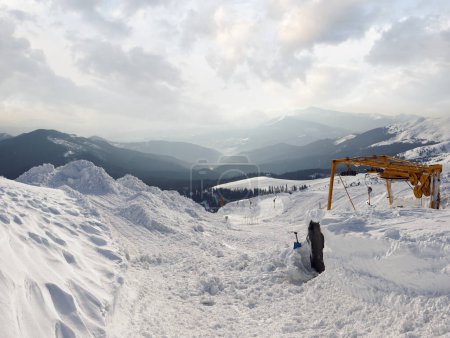 Photo for Snow-covered ski hoist ropeway (upper  terminal) and mountain landscape behind (Ukraine, Carpathian Mt's, Drahobrat ski resort). Four shots stitch image. - Royalty Free Image