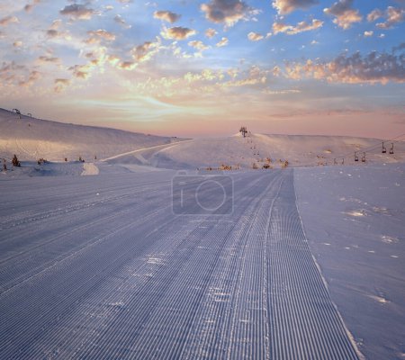 Photo for Alpine resort prepared ski slopes and lifts. Pre sunrise morning mountain ridge view. Dragobrat, Ukraine Carpathians. - Royalty Free Image